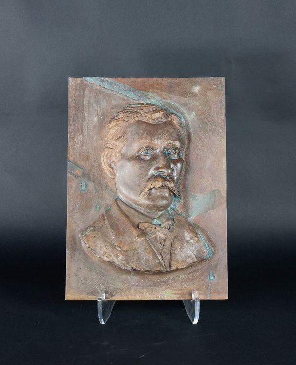 A bronze portrait plaque